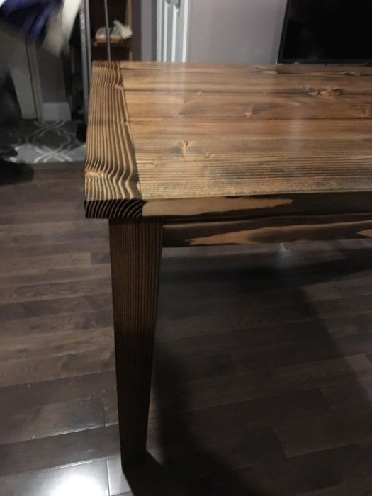 brown wood table with breadboard ends and tapered legs